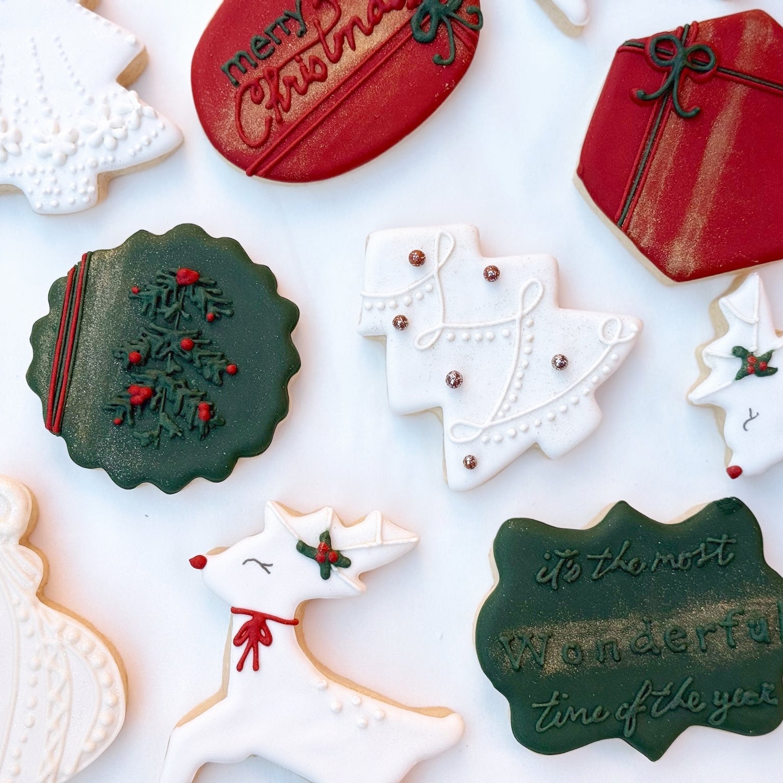 Collection of holiday luxe cookies with various designs on a white background