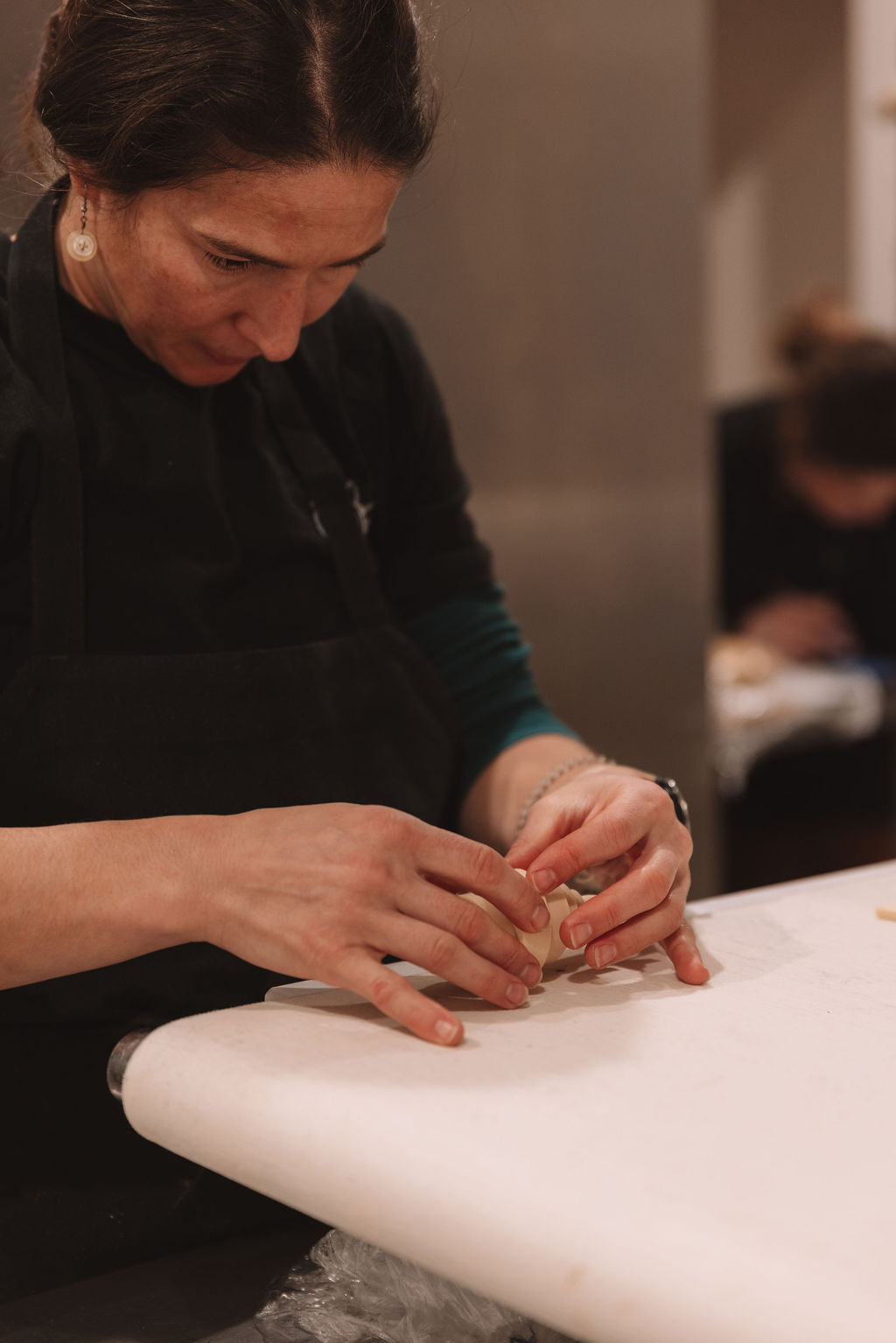 Hand-shaping pastries in the kitchen